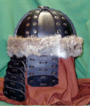 Our leather Mongol Helm shown in black with nickel rivets, lamellar cheekplates and aventail with natural rabbit fur trim.