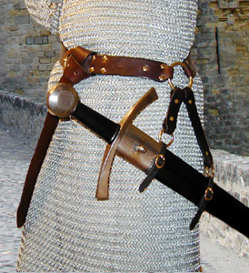 Our Sword Belt of the Circle is based on an example in a late Medieval painting. Shown in dark brown leather with brass hardware.